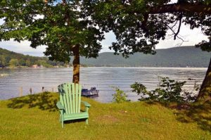 Adirondack chair outside of the Chestnut Lodge, our rustic cottage rental on Lake George